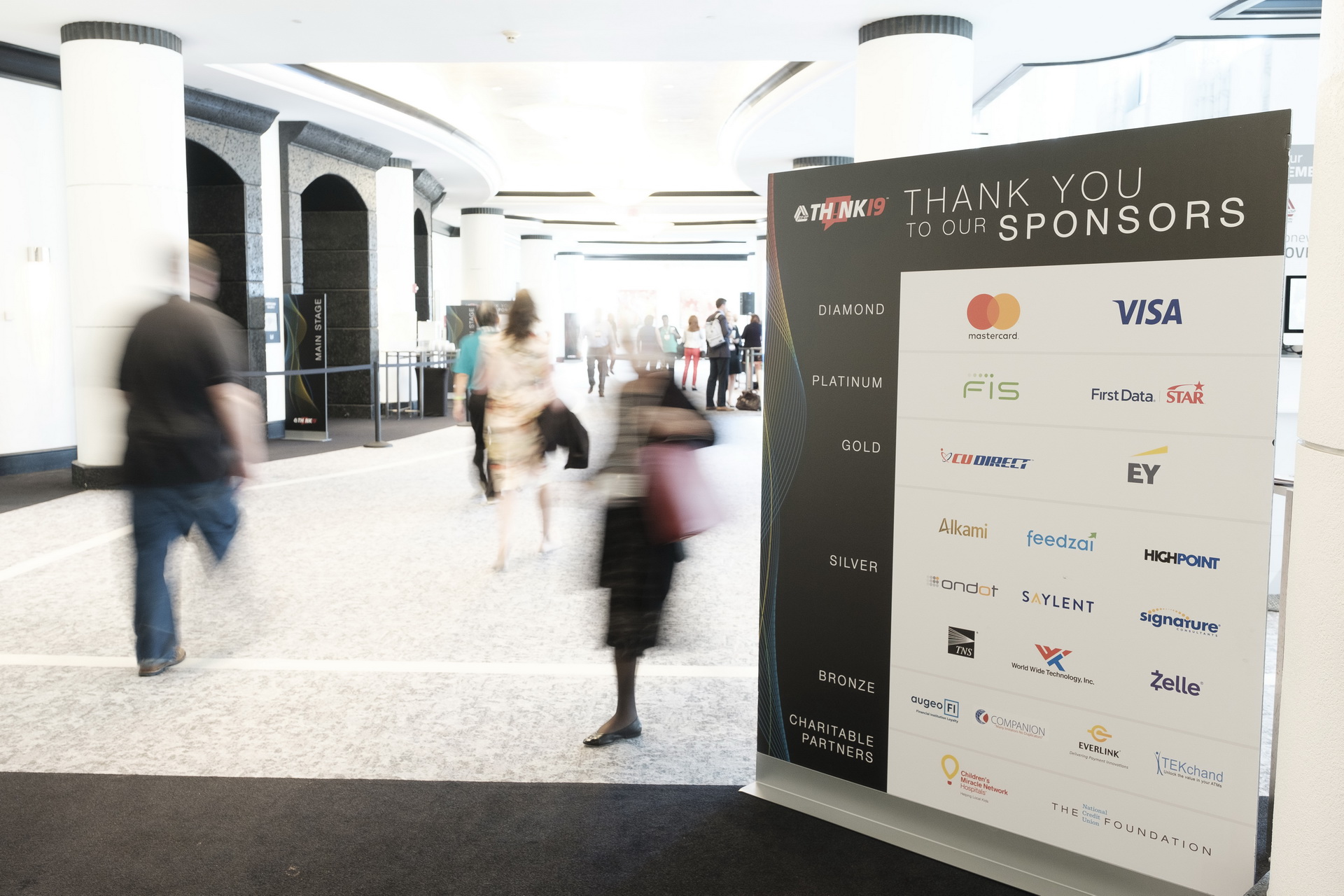 blurred image people walking sponsorship speakers on stage business corporate conference seminar