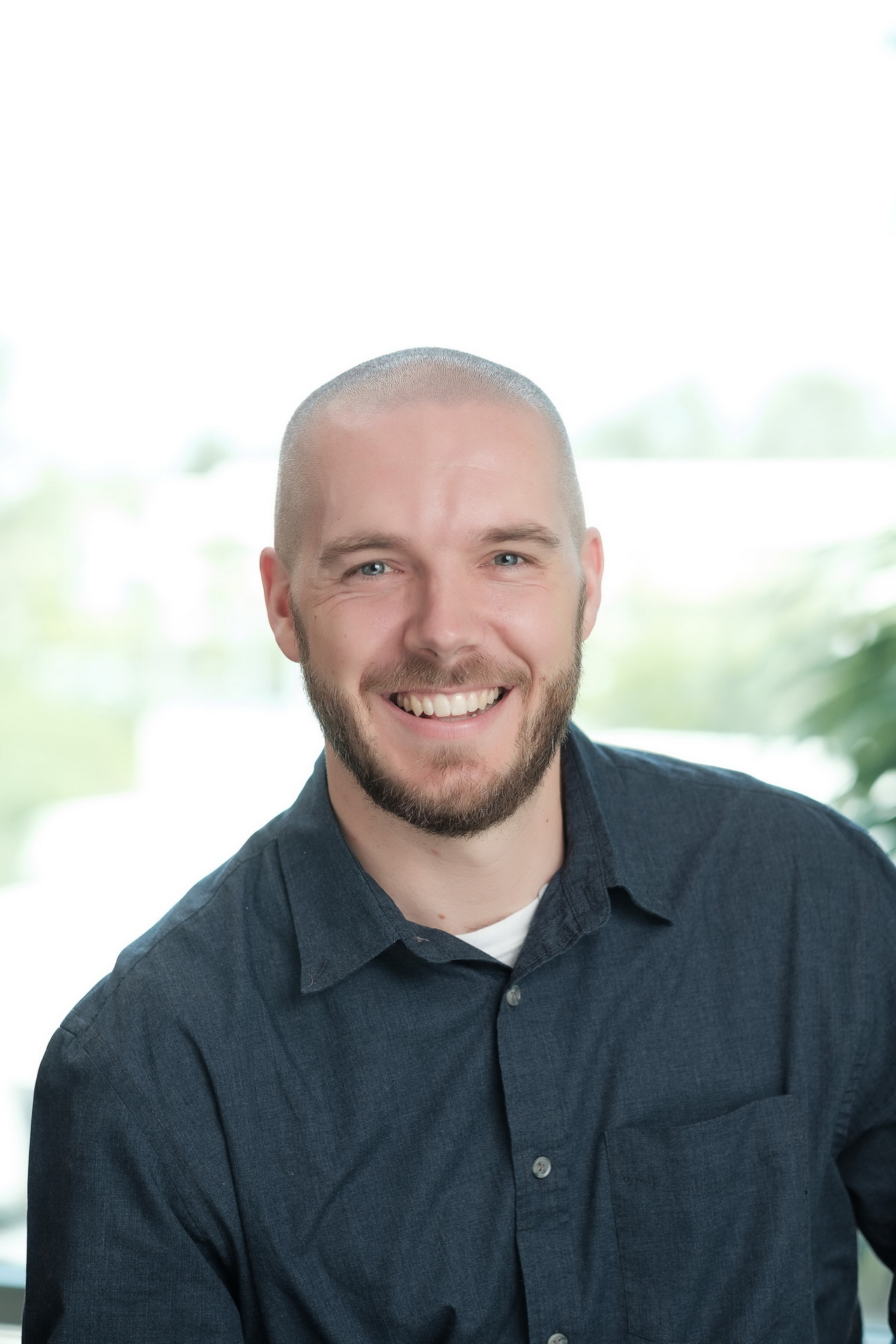 relaxed business headshot enviornmental portrait white backdrop modern