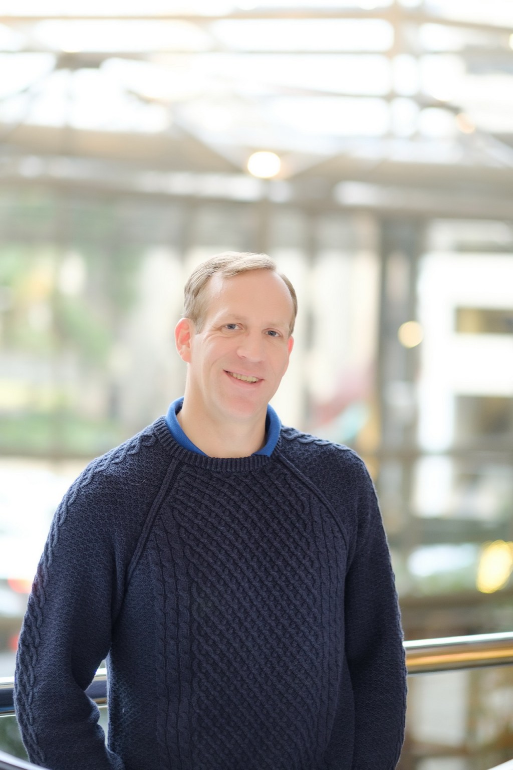 relaxed business headshot enviornmental portrait blurred backdrop