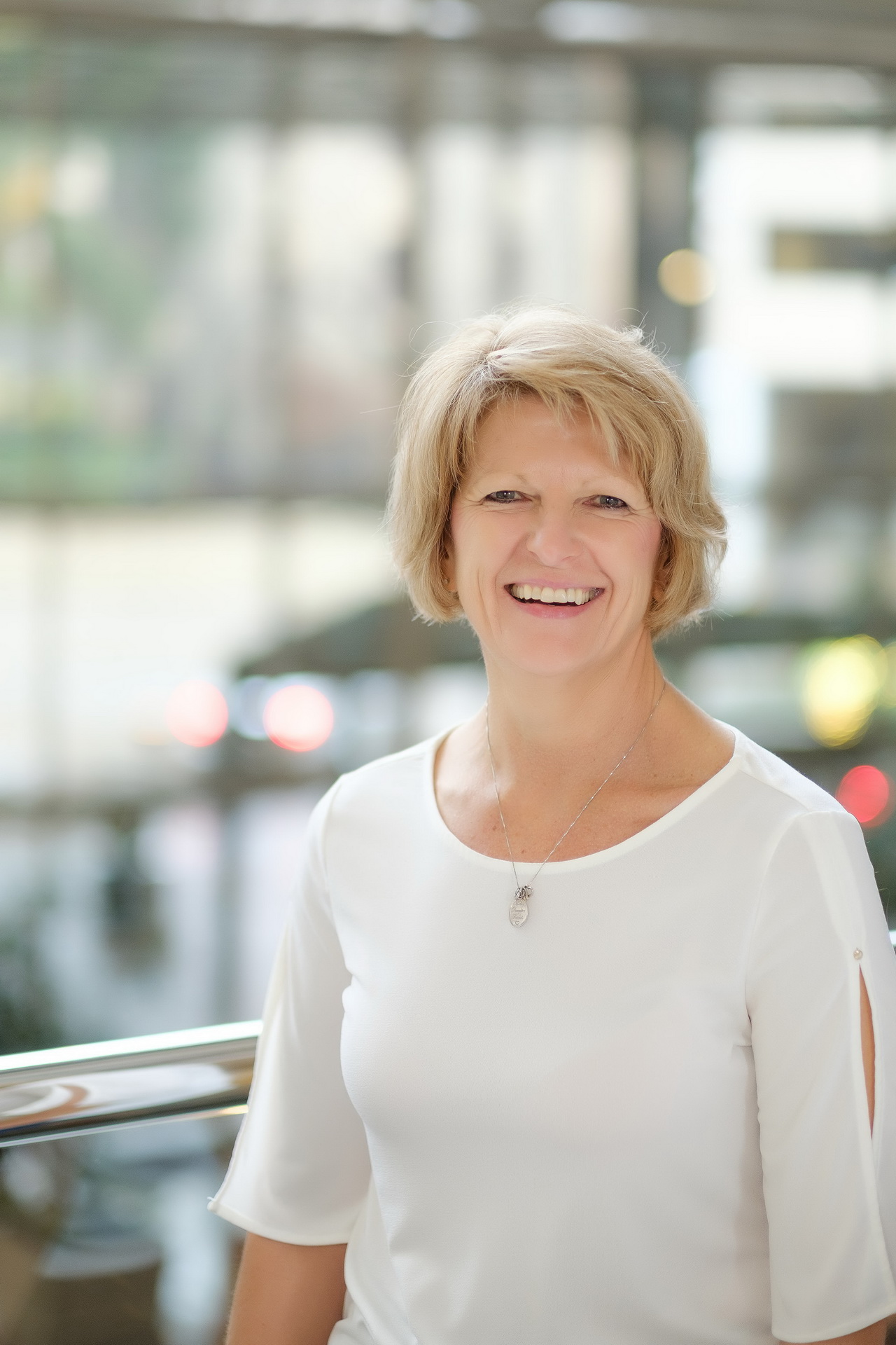 relaxed business headshot enviornmental portrait blurred backdrop